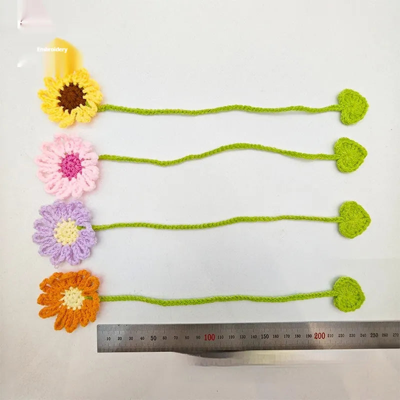 Hand-crocheted daisy flexible wire bookmark in yellow, pink, light purple, and orange colours.