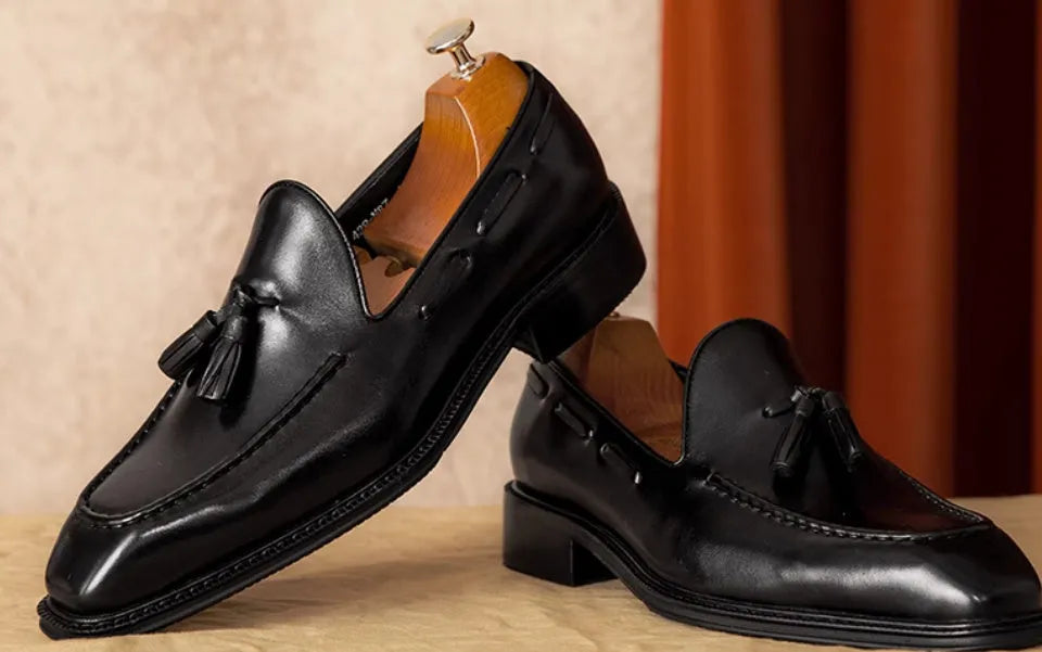 Men's black genuine leather slip-on loafers with fringed design and rubber sole