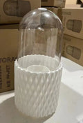 White rotating acrylic makeup brush storage box with transparent dustproof lid on dressing table