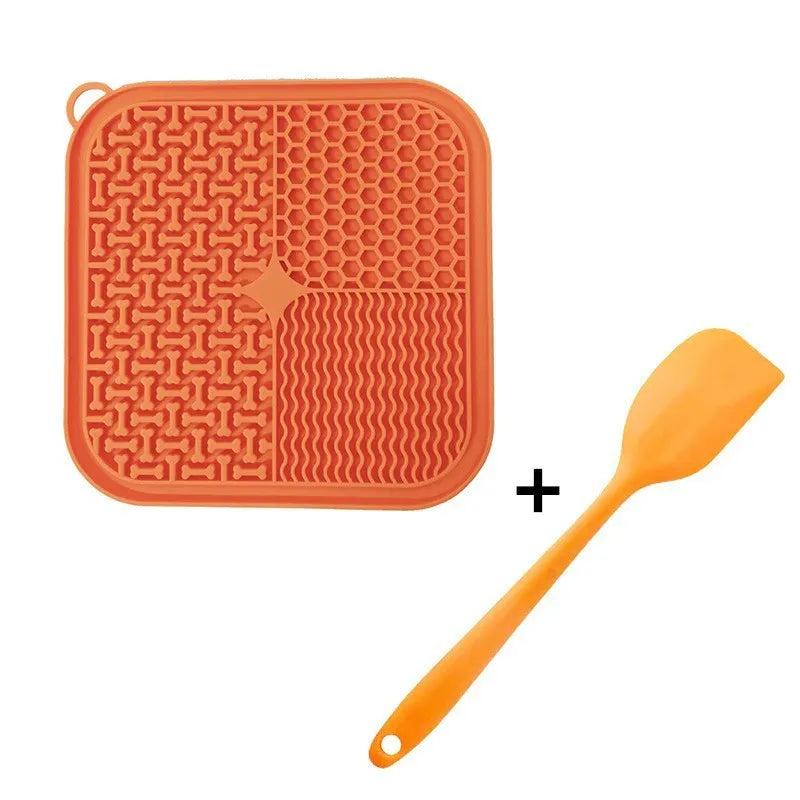 Square orange-red and grey silicone dog lick mat with textured surface and suction cups on the back.