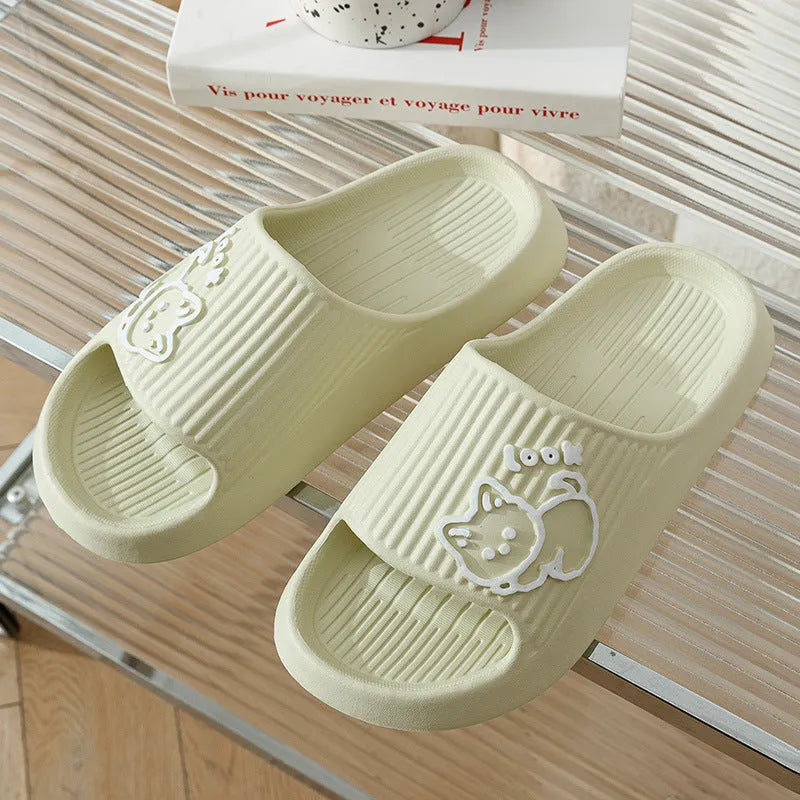 Green EVA platform flip flop slippers with a raised cat design on the upper.