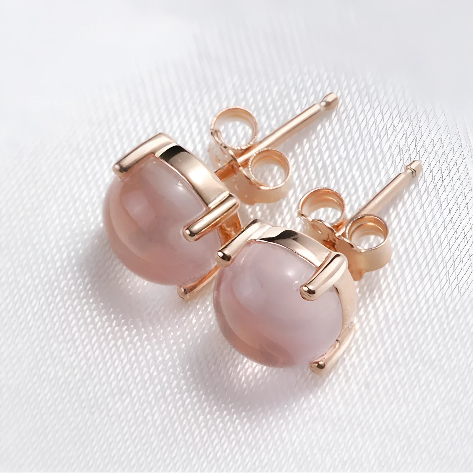 Women's rose gold drop-shaped stud earrings with synthetic Ross quartz and crystal inlay detail