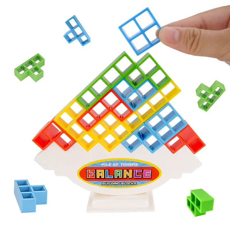 Plastic balance stacking game with 16 coloured building blocks, chassis, and base on a table