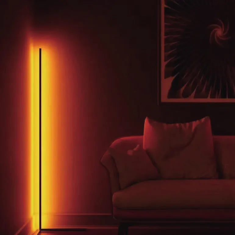 Black smart RGB floor lamp with remote control on household floor