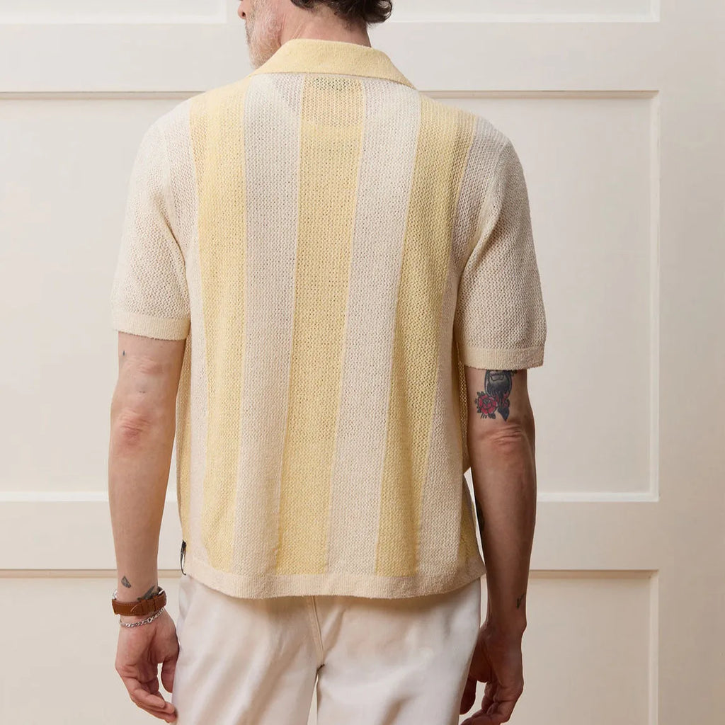 Yellow women's Tencel polo shirt with an asymmetric hemline and hollow-out detail on a short sleeve.