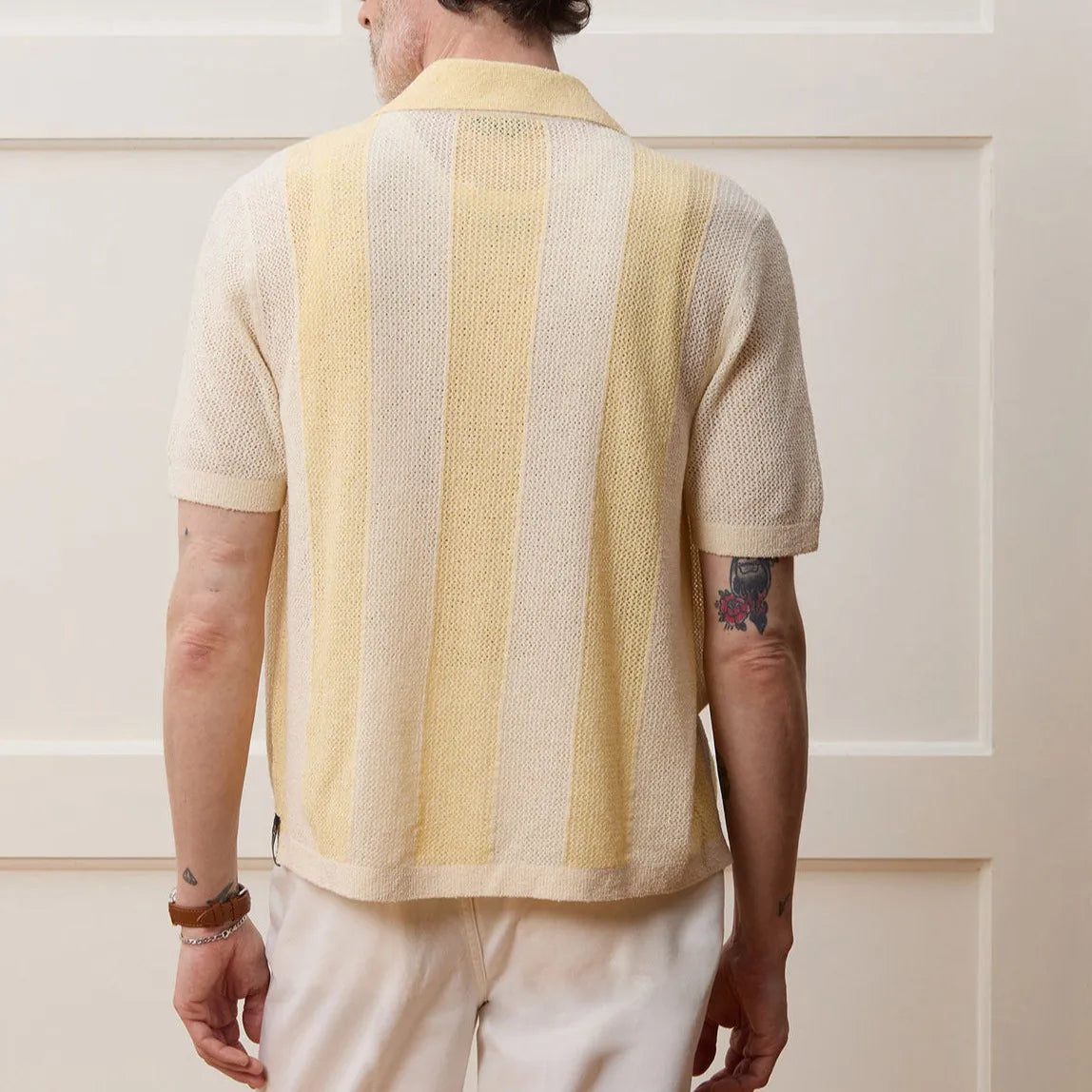 Yellow women's Tencel polo shirt with an asymmetric hemline and hollow-out detail on a short sleeve.