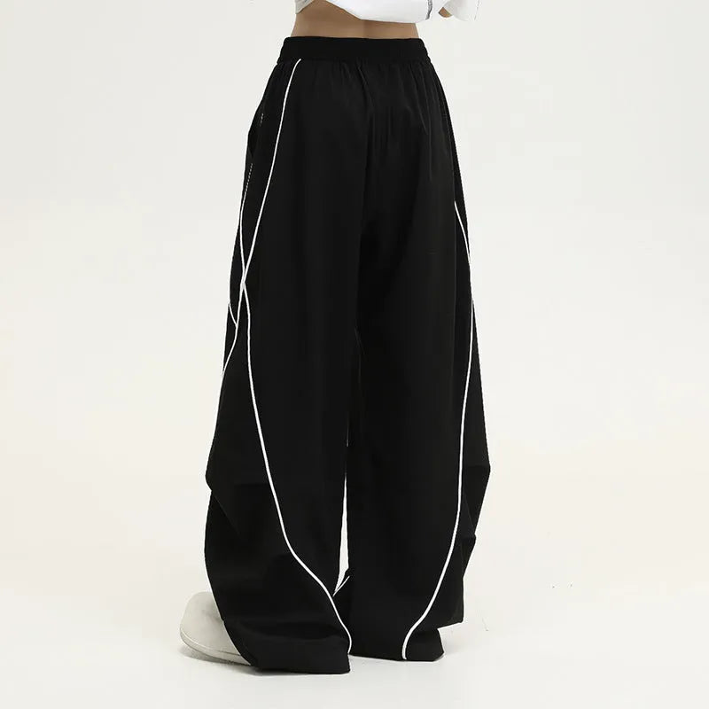 Black pleated wide-leg hip hop pants with striped pattern and mid waist, loose fit polyester streetwear trousers