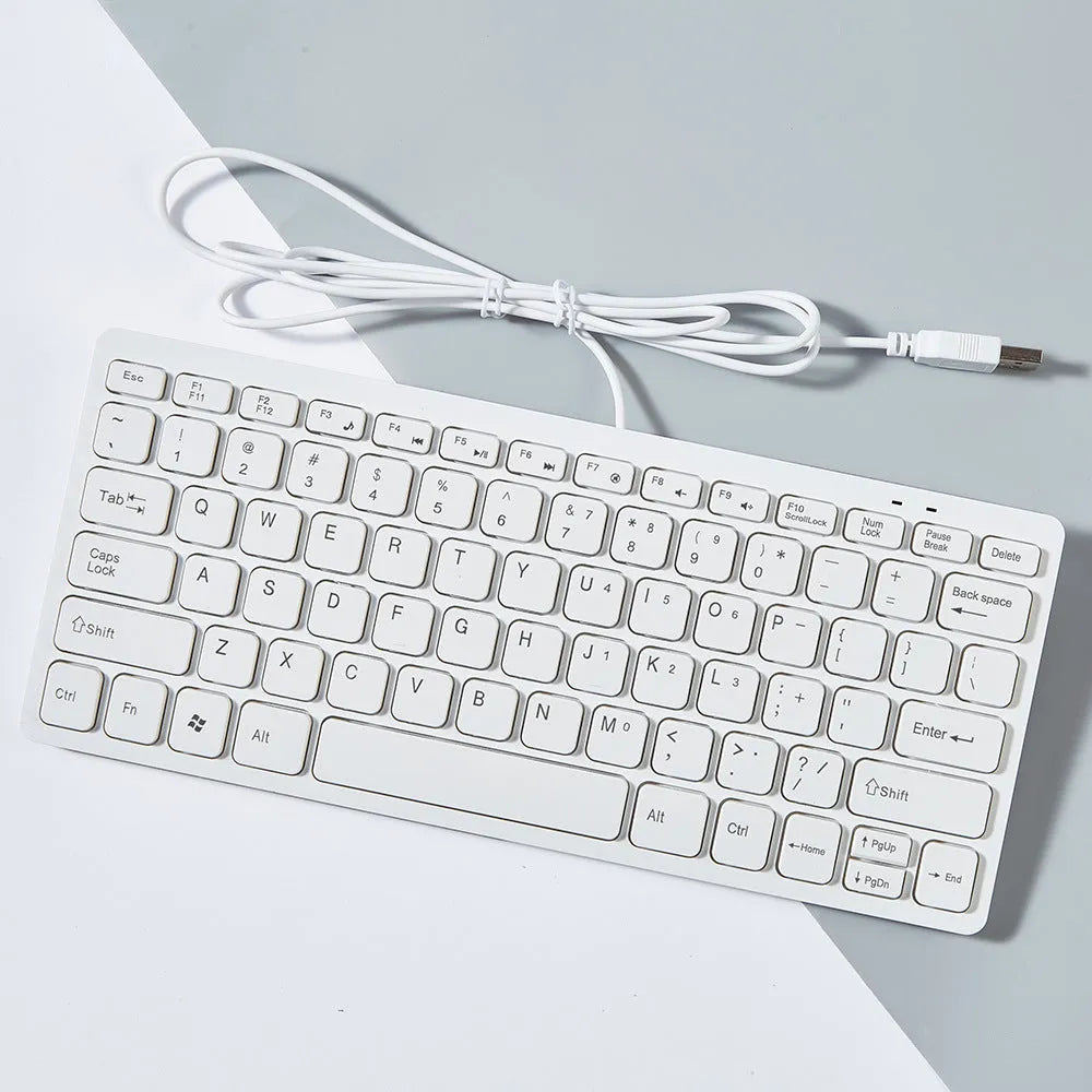 Mini wired USB computer keyboard in black, white, pink, or blue colour options.