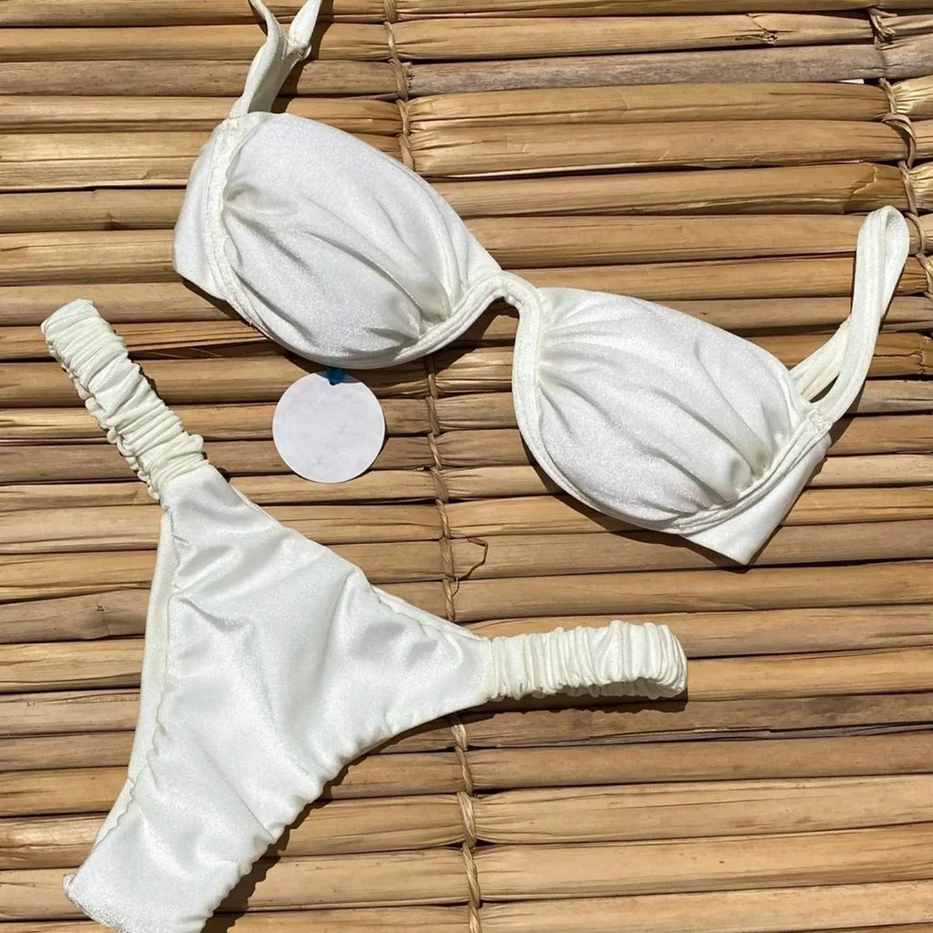 Women's black underwire bikini swimsuit set with split briefs on a neutral background.