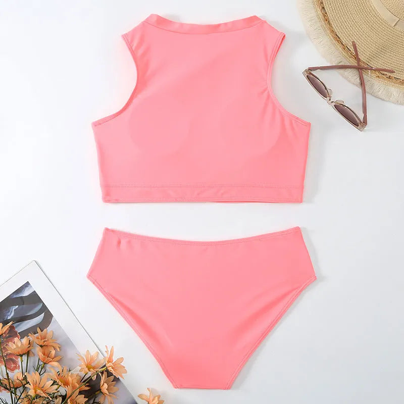Pink high-waist bikini set with sleeveless top and split-leg shorts on a mannequin.