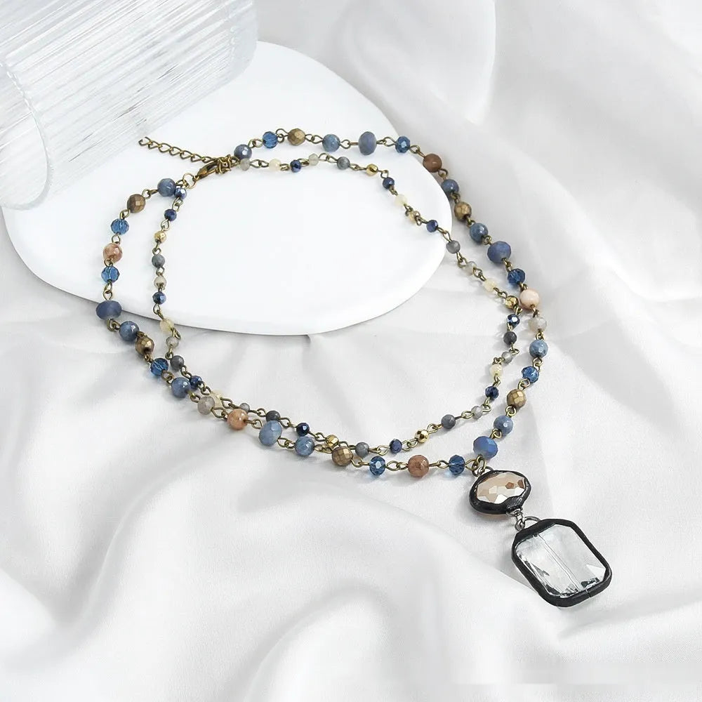 Two-layer tribal necklace with glass and natural stone pendant on adjustable alloy chain in beige colour