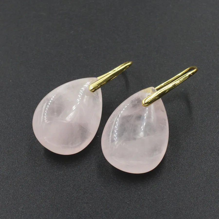 A pair of geometric water drop earrings made from crystal in one of nine colours, with an electroplated metal setting.