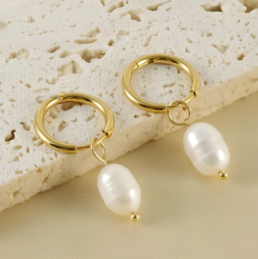 Geometric gold stainless steel earrings with pearl accents on white background