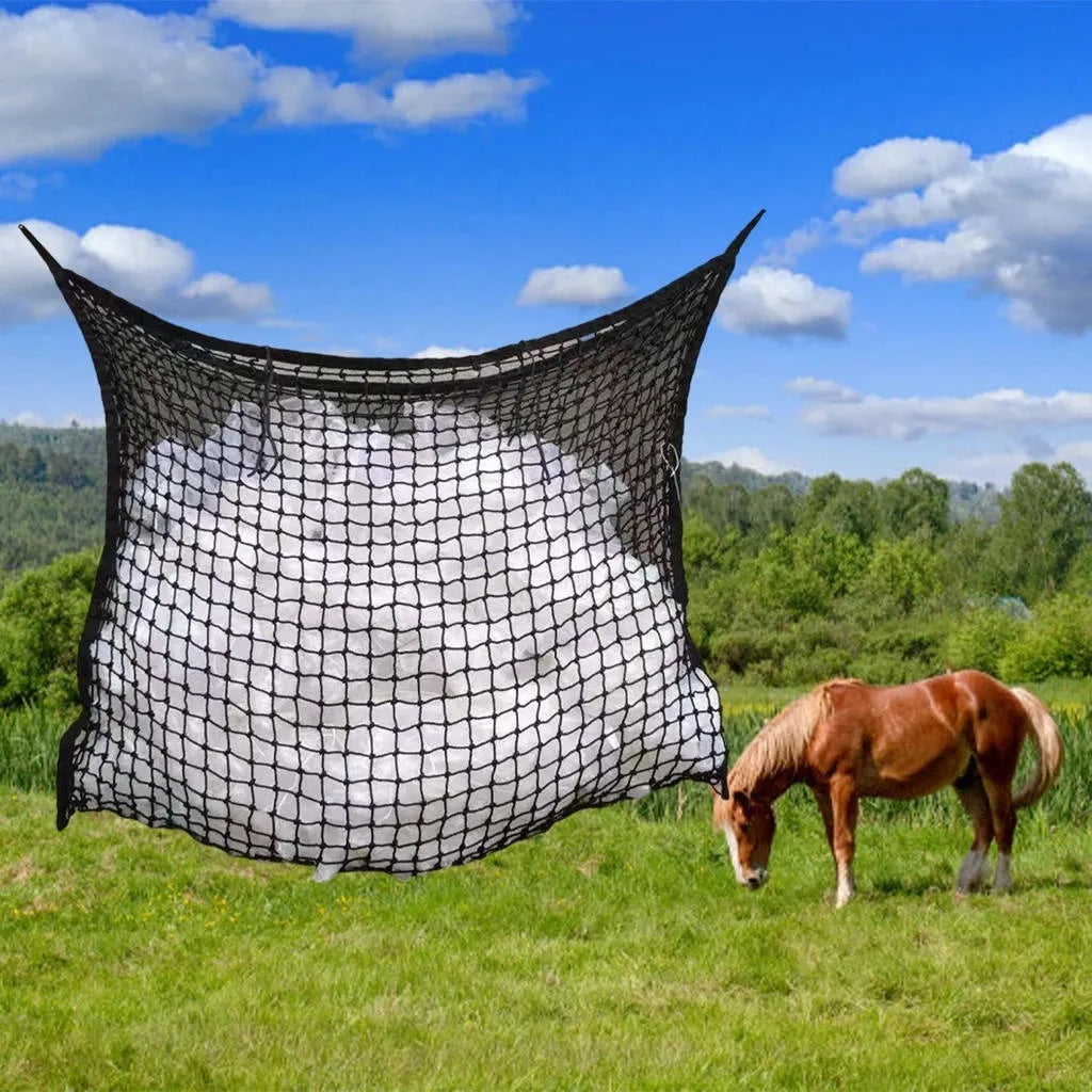 Woven PE rope mesh horse feeding bag hanging with hay inside, black colour shown
