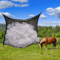 Woven PE rope mesh horse feeding bag hanging with hay inside, black colour shown