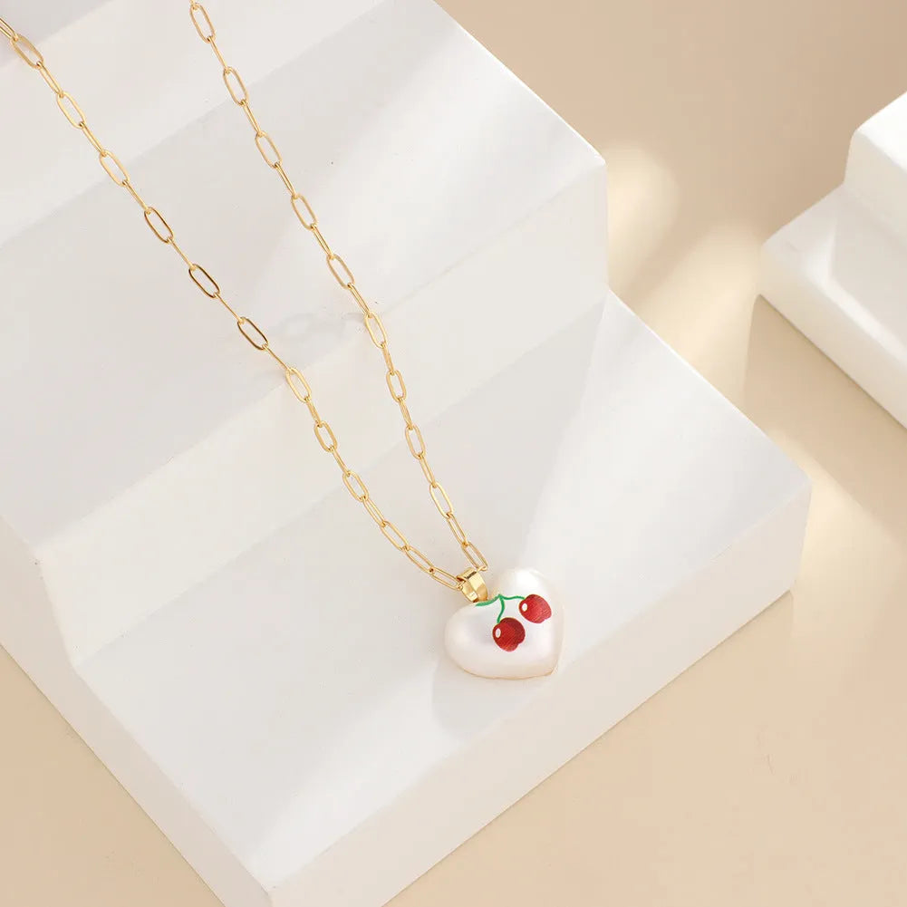 Adjustable girls necklace with a choice of apple, cherry, pear, pineapple, or strawberry heart-shaped pendant.