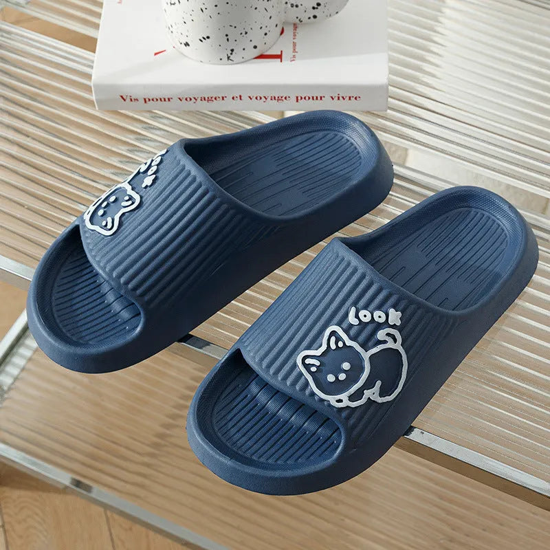 Green EVA platform flip flop slippers with a raised cat design on the upper.