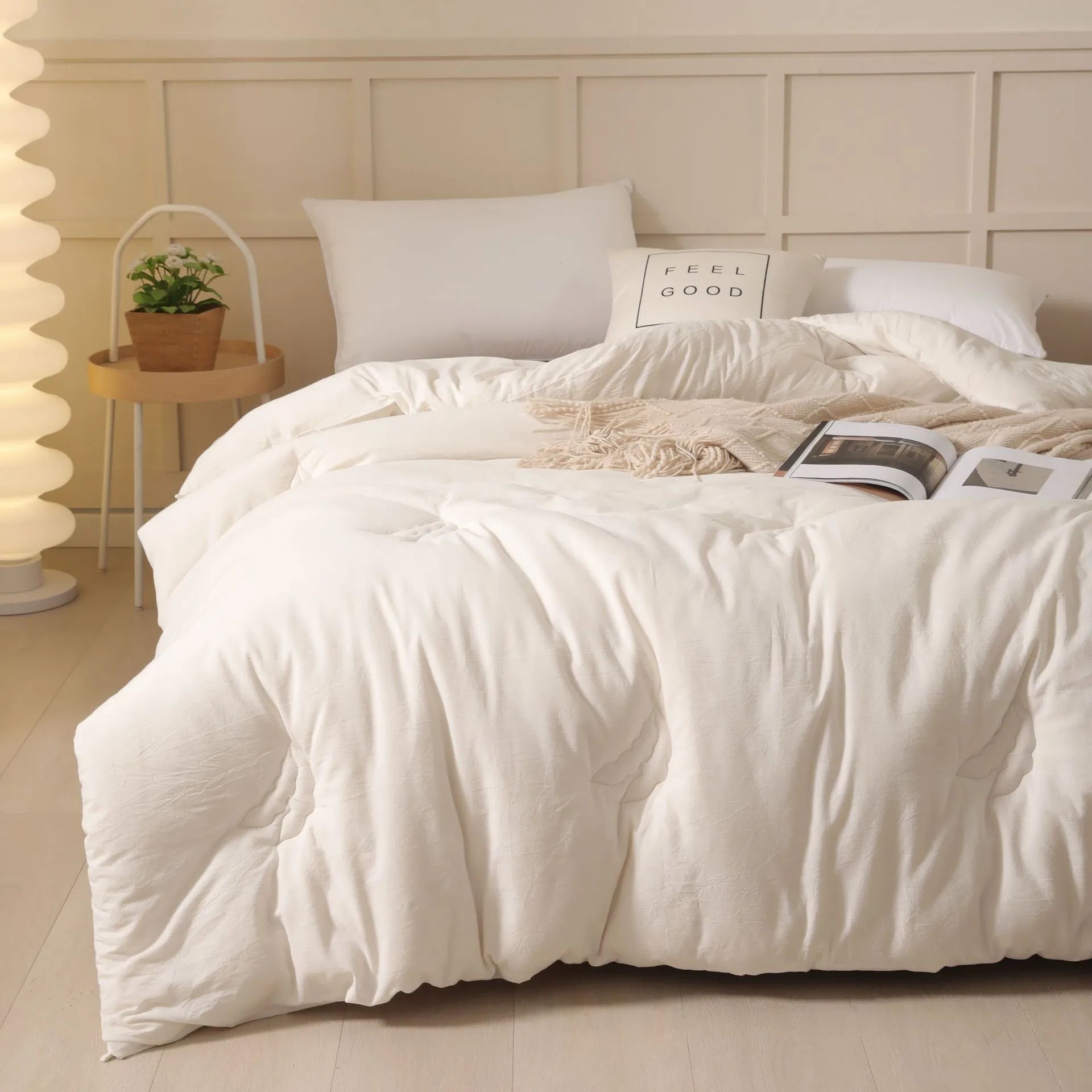 A pure cotton soybean fibre airable quilt in grey, shown with a zipper detail, on a bed.