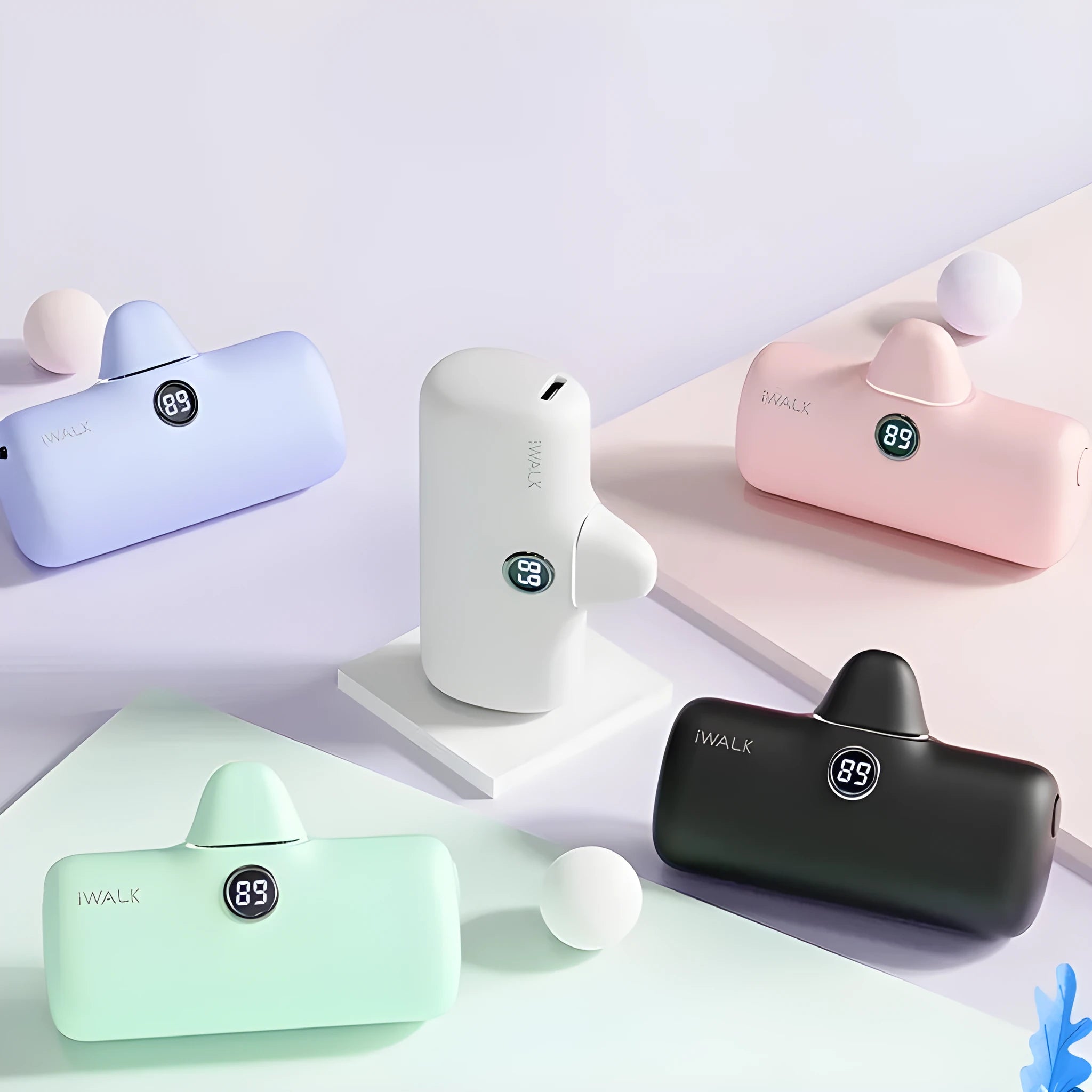 Compact cylindrical lipstick-style power bank showing colour options and display screen.
