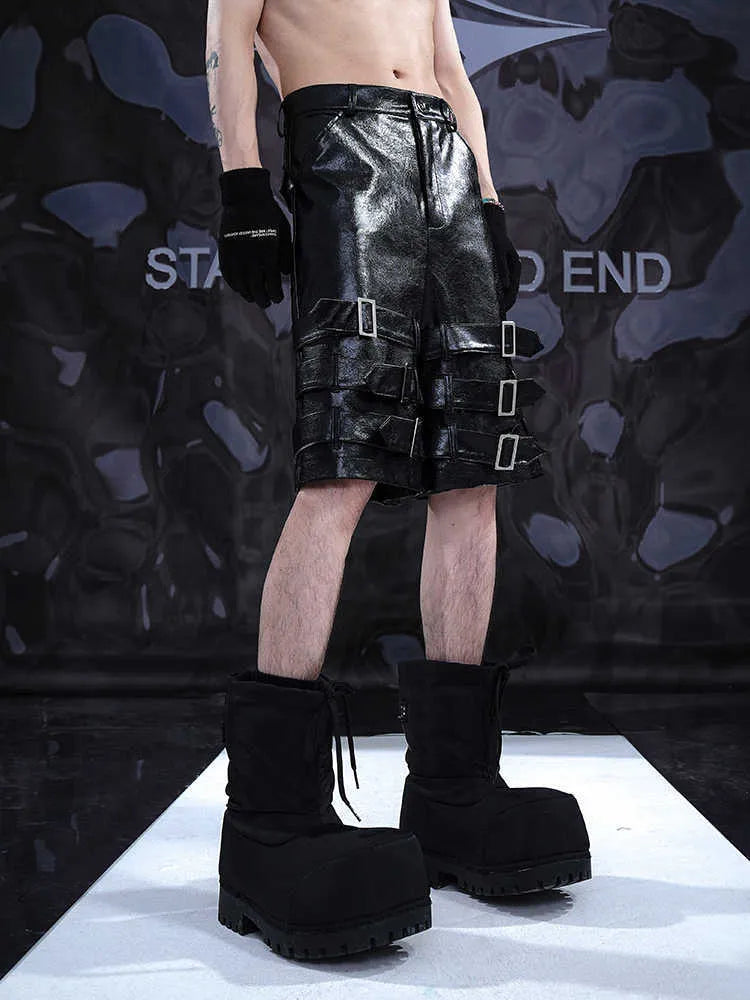 Black men's PU leather-look cropped shorts with a medium-low waist on a mannequin.