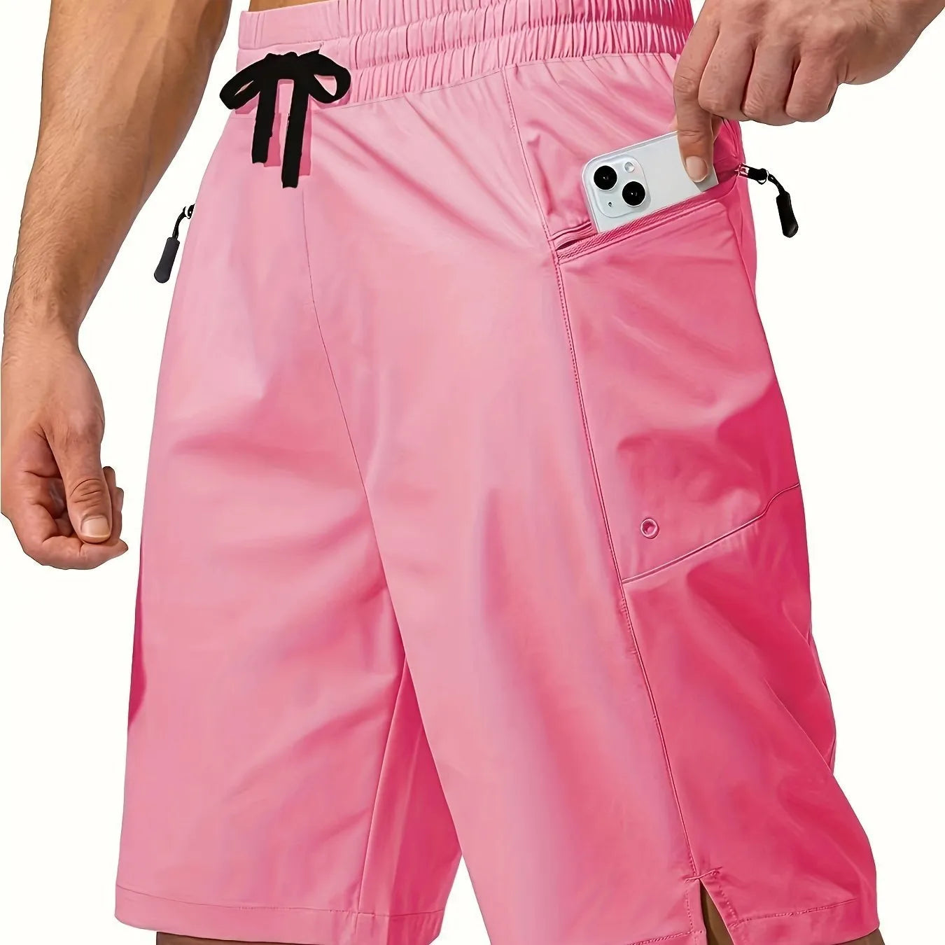 Man wearing solid colour quick-drying polyester beach shorts in a straight leg fit.