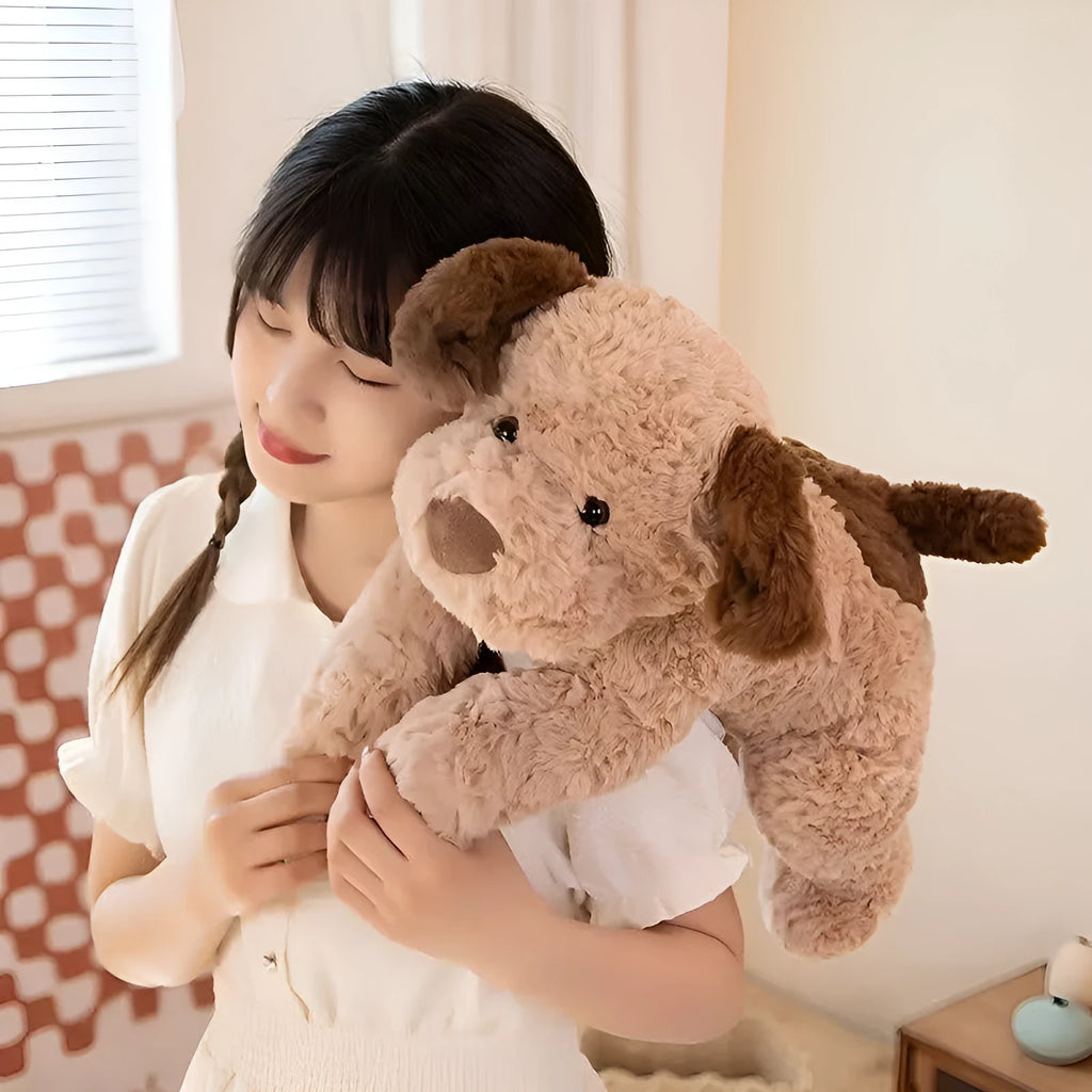 Plush toy lying dog doll in brown faux fur, 35cm height, lying on a soft surface