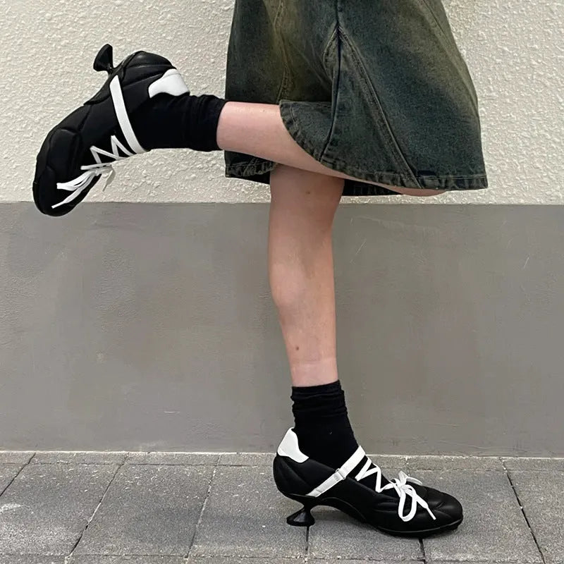 Women's silver lace-up sports shoes with a bow detail and round toe on a mid heel.