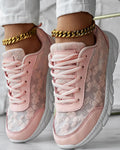 Women's white canvas running shoes with soft sole and flat heel on a plain background.