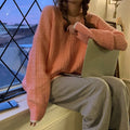 Women's lake blue loose fit pullover sweater on a hanger, front view.