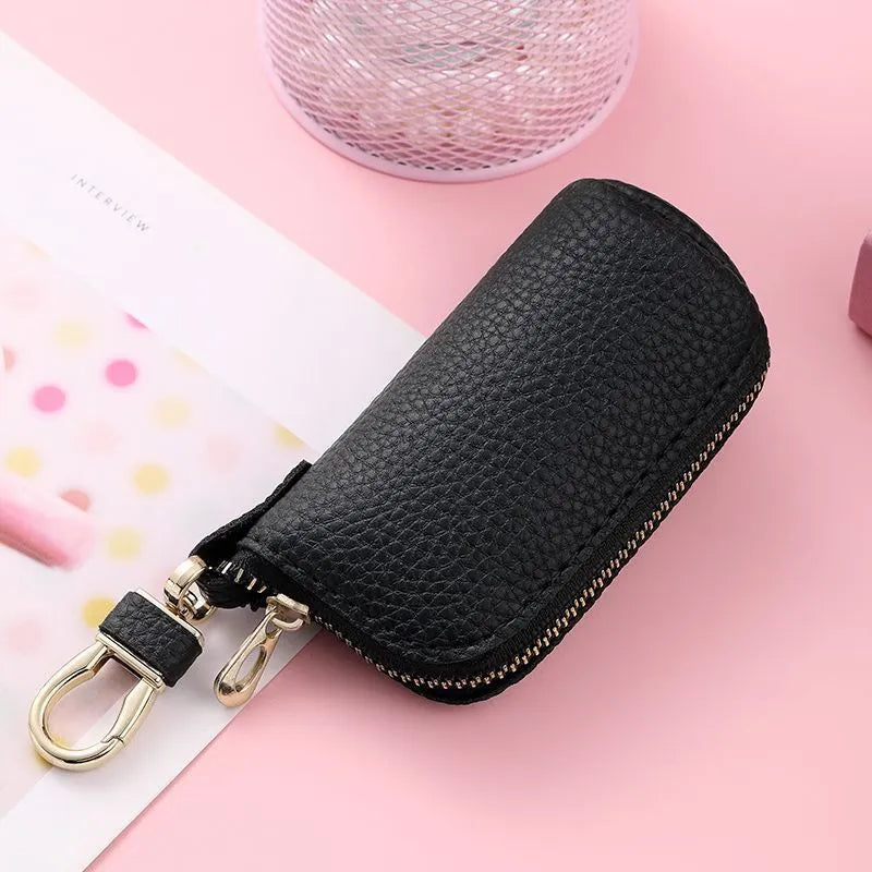 Men's black PU leather zipper key ring organiser case on a grey background.