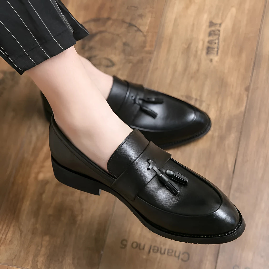 Men's black and brown business casual slip-on shoes with tassel detail and rubber soles