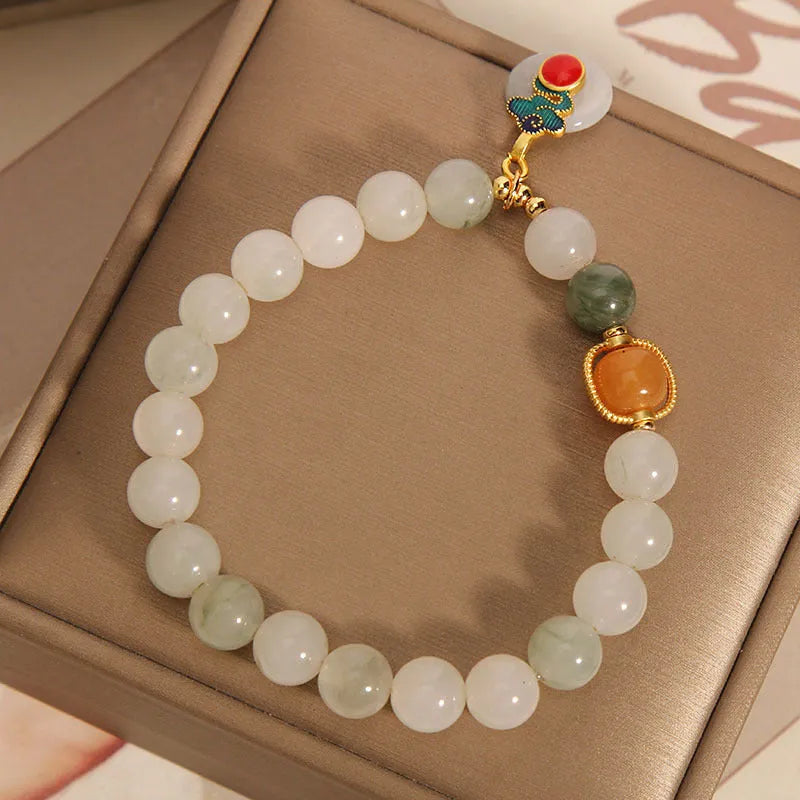 Women's ice jade crystal bracelet with pearl accents and a jade buckle on a white background.