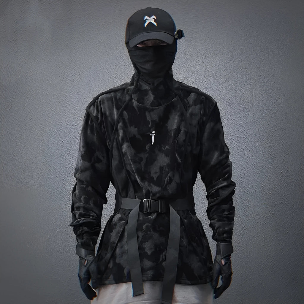 Man wearing a black and grey tie dye printed finger turtleneck sweater with drop shoulder sleeves.