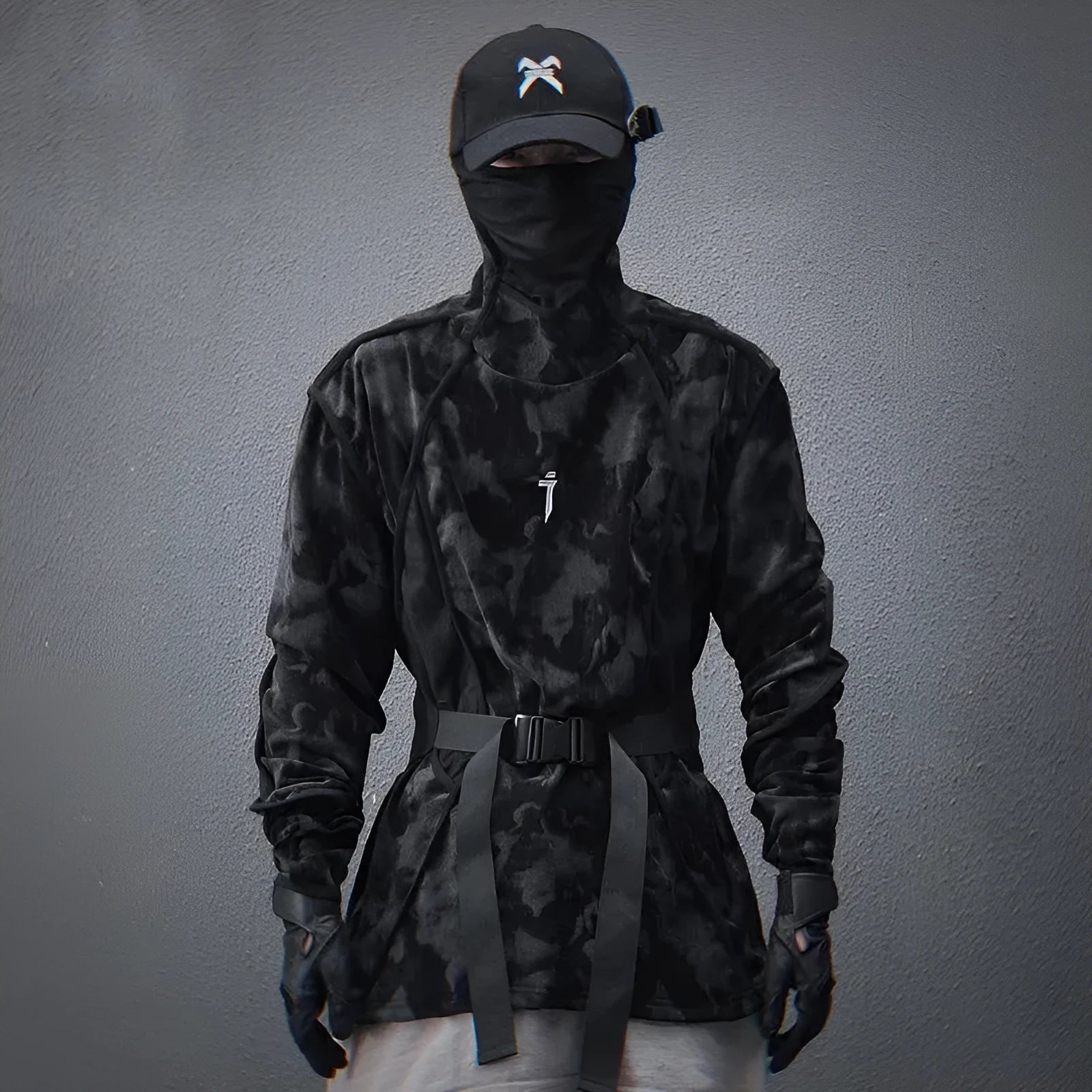 Man wearing a black and grey tie dye printed finger turtleneck sweater with drop shoulder sleeves.