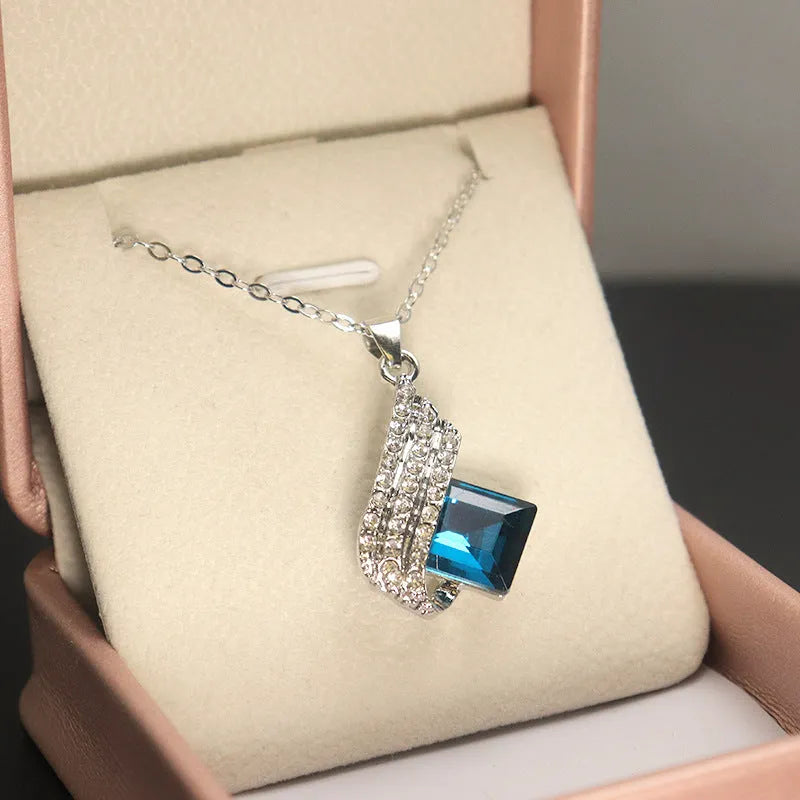 Women's necklace and earring set with glass pendant on cross chain, electroplated finish