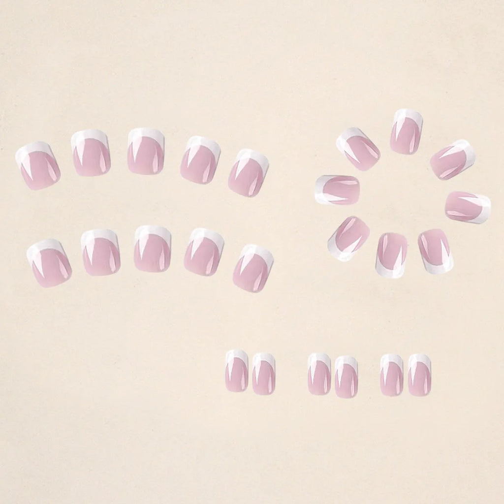 24 white plaid-pattern false nail tips laid out on a surface