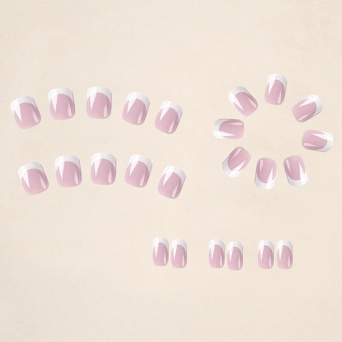 24 white plaid-pattern false nail tips laid out on a surface