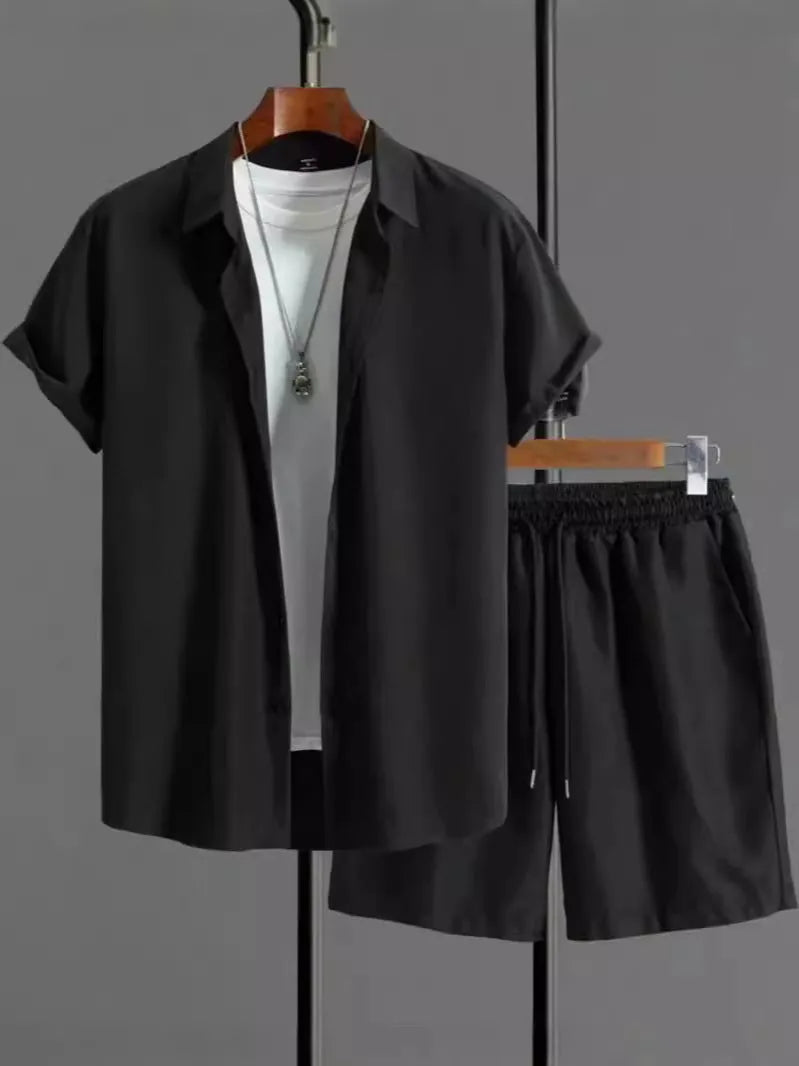 Man wearing a grey jacquard short-sleeve suit jacket and matching shorts.