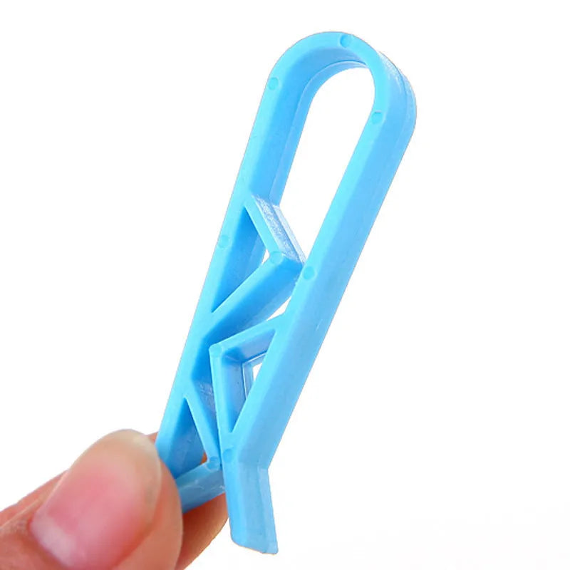 White plastic rubbish bag clip with adjustable 16mm jaws for securing bin liners.