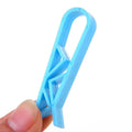 White plastic rubbish bag clip with adjustable 16mm jaws for securing bin liners.