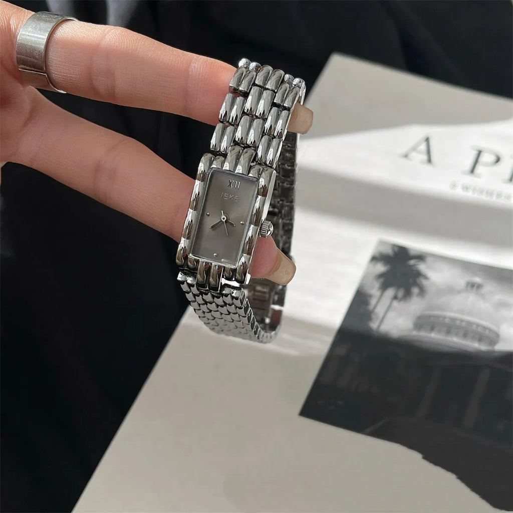 Women's bracelet-style watch with 15mm dial, mineral glass, and butterfly buckle in silver or gold finishes