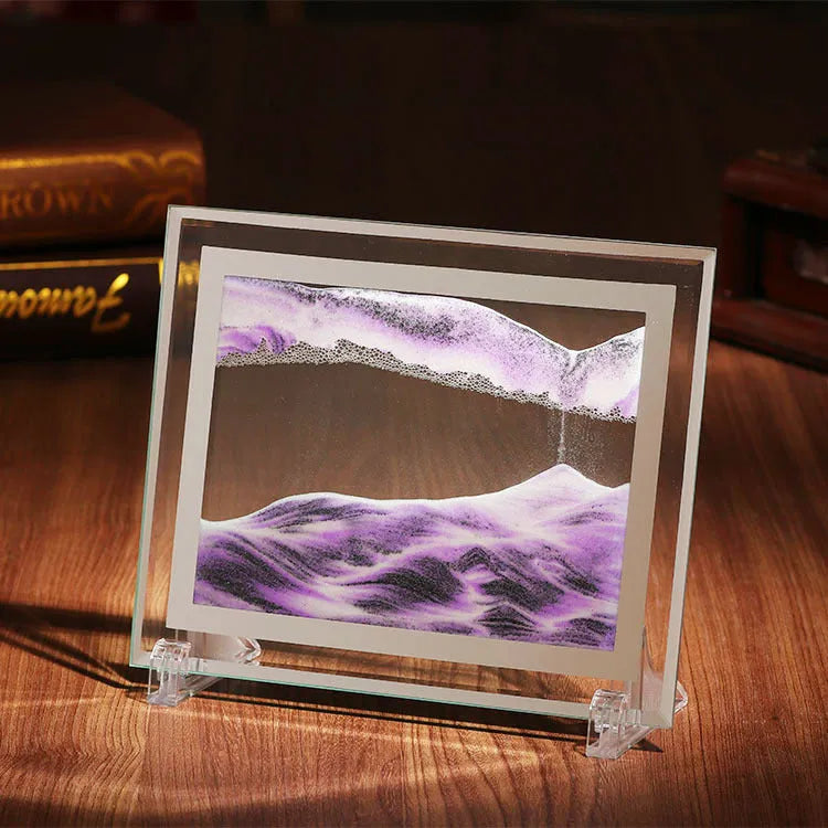 Glass quicksand painting ornament with geometric shape showing landscape sand art in black and white green colours.