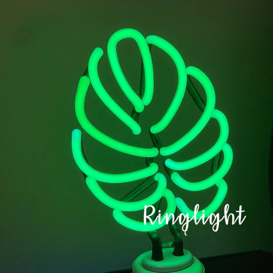 Creative minimalist bamboo-shaped desk lamp with green light on a white background.