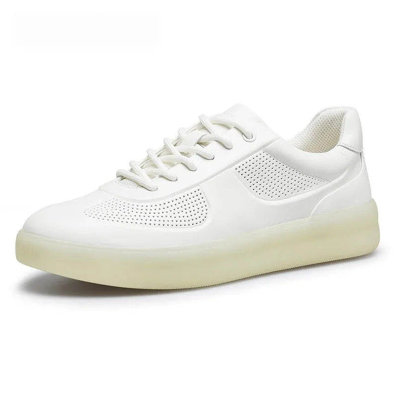 white perforated leather casual training shoes with rubber sole and front lace-up on flat surface