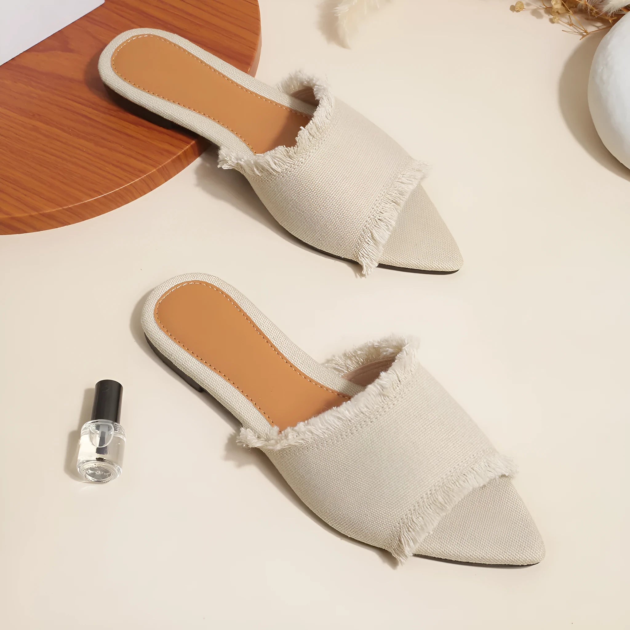 Women's denim flat slippers with tassel detail and leather lining in multiple colours.