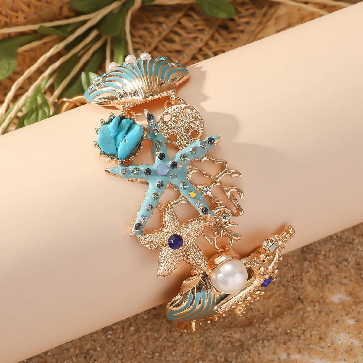 Alloy rhinestone starfish bracelet with boat anchor charm in blue, red, or turquoise.