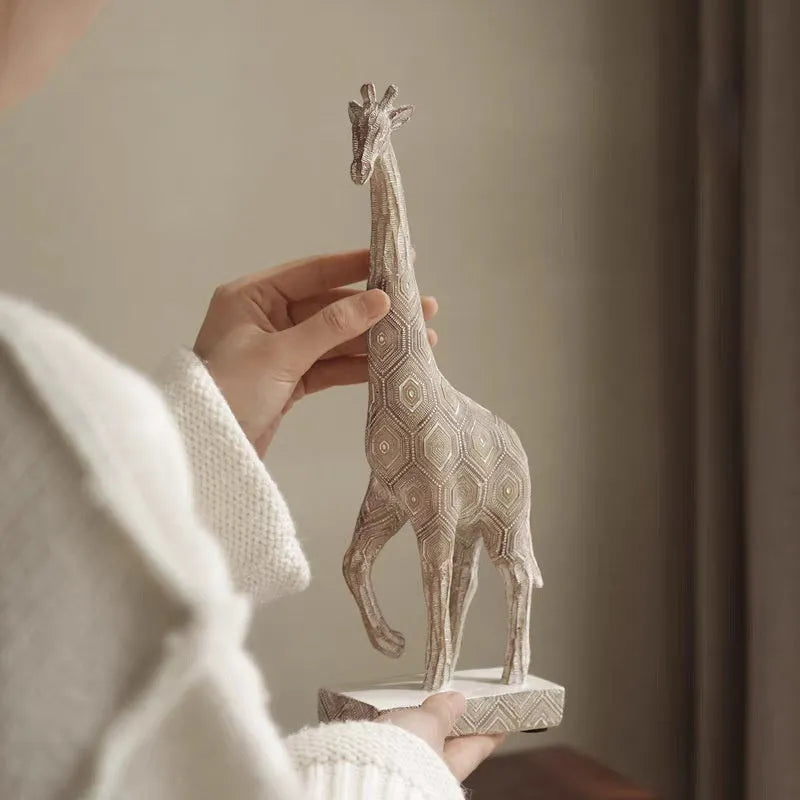Wood colour giraffe resin ornament on a shelf, showing European style sculptural details.