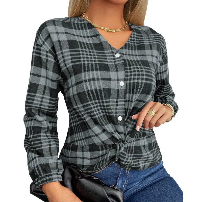 Woman wearing a loose-fitting purple, grey, and red plaid casual shirt with regular sleeves.