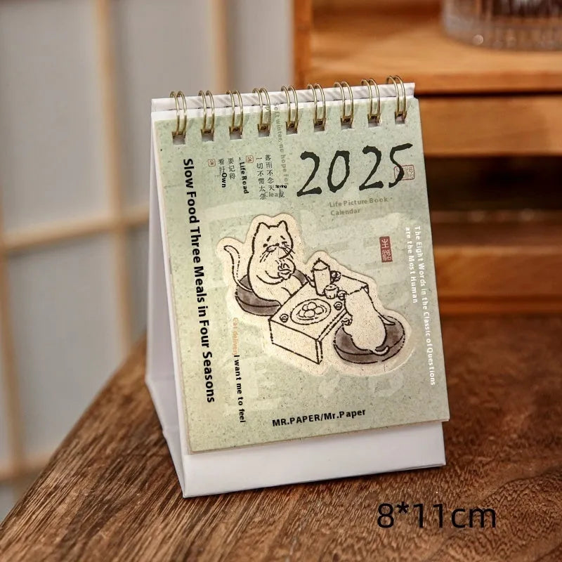 Mini 2025 desk calendar in a simple modern design on a wooden desk