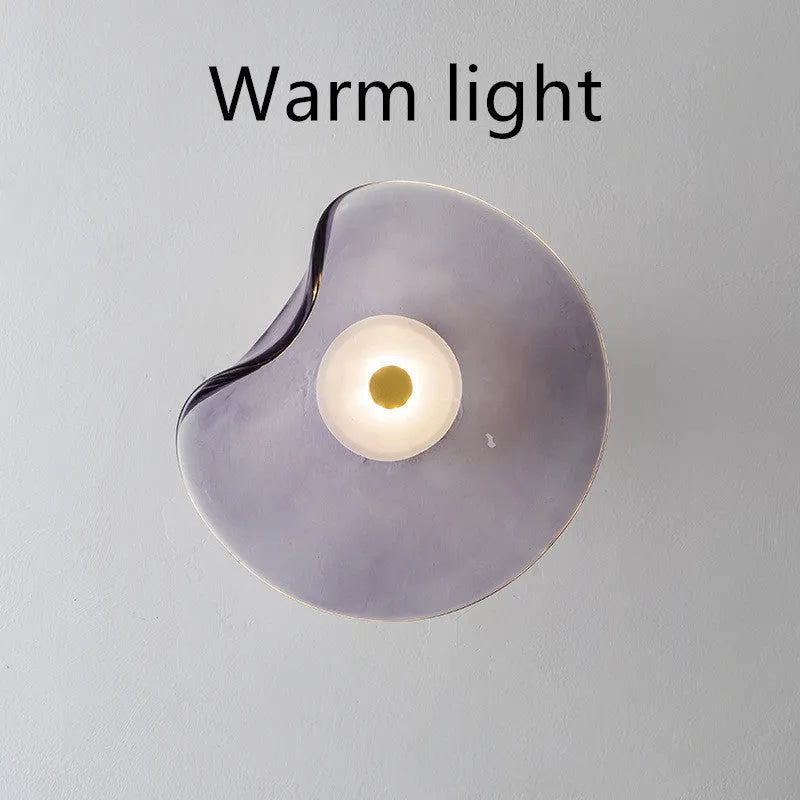 Round decorative wall lamp with glass shade for bedroom bedside lighting